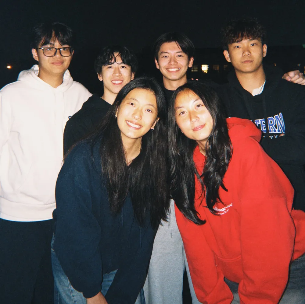 The six-person Bounce team posing together outdoors at night