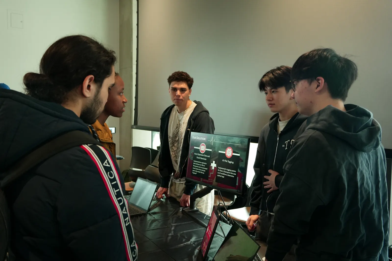 Nathan walking visitors through the team's Red Cross solution at the GENESIS booth